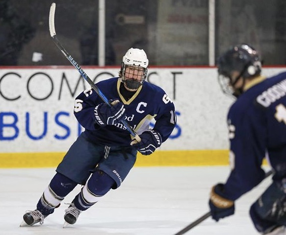 Falcon hockey player flying on the ice to receive a pass from his fellow Falcon.