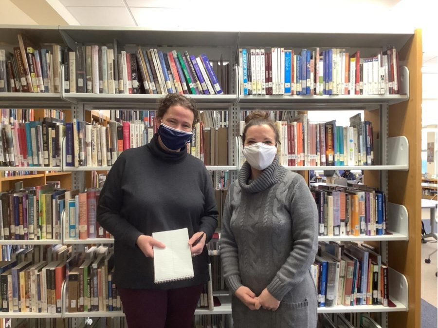 The staff of Good Counsel’s Steve Dean Memorial Media Center (L to R: Ms.Carol Boyle and Ms.Amelia Davis) standing in front of the abundance of books that the Media Center has to offer.