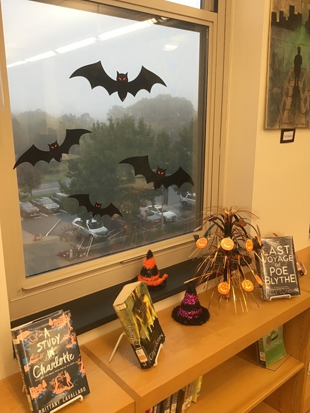 Halloween+decorations+on+the+library+window+during+a+foggy+morning.+%0A
