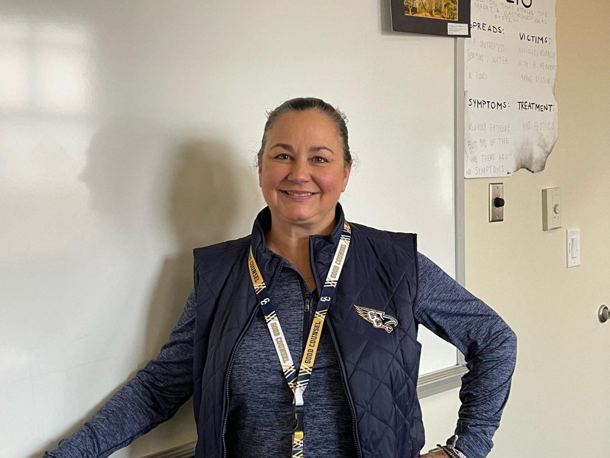 Ms. Aileen Shaffer stands in front of the dry erase board in her classroom.