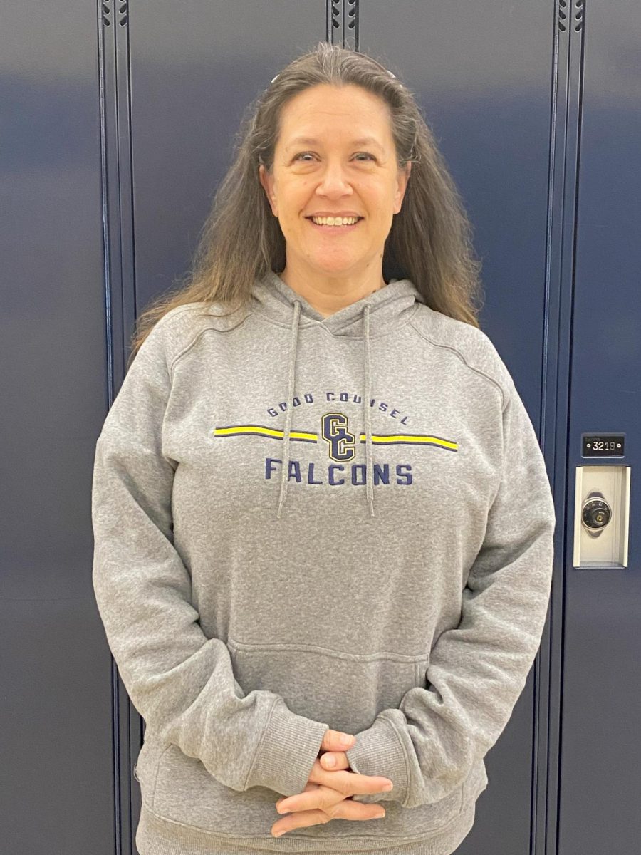 Ms. Natasha Bowlds poses in front of the student lockers.