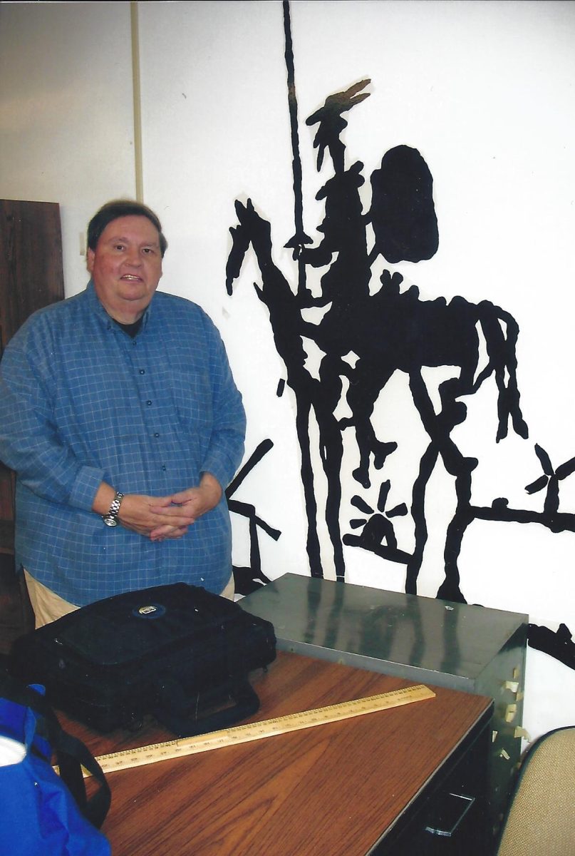 Mr. Essig poses with a sculpture of his favorite fictional character, Don Quixote. This is a photo from a past GC yearbook.